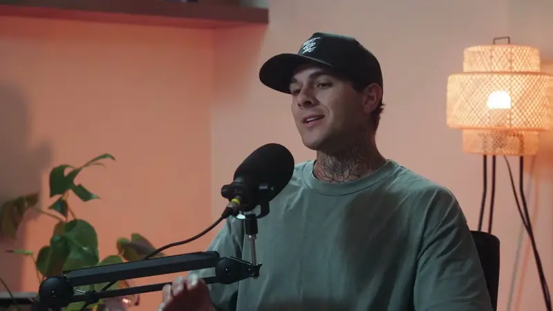 Wyatt Coats speaking into a microphone on Faith Unfolded